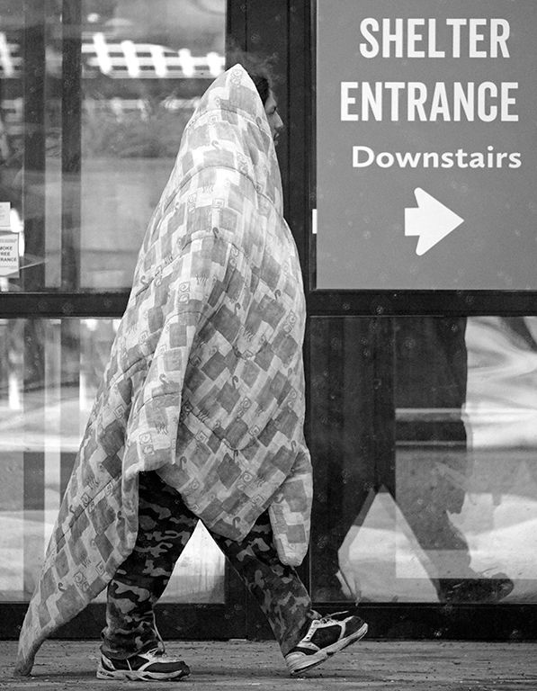 A man makes his way to a temporary winter homeless shelter at the Edmonton Convention Centre on January 25, 2021.