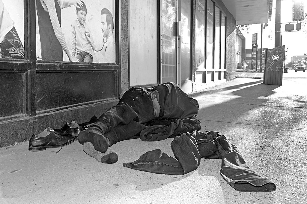 A man sleeps on the street in downtown Edmonton on September 5, 2021.
