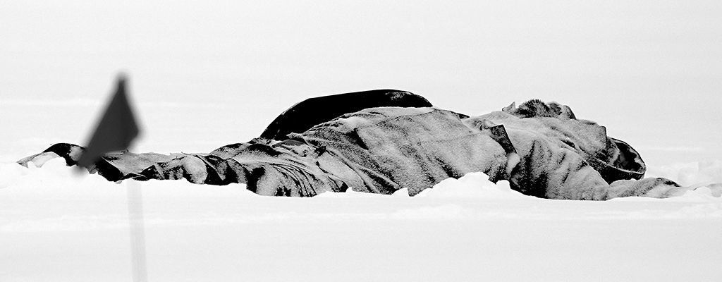 The frozen body of a suspected homeless male lays in the snow near downtown Edmonton, Canada.