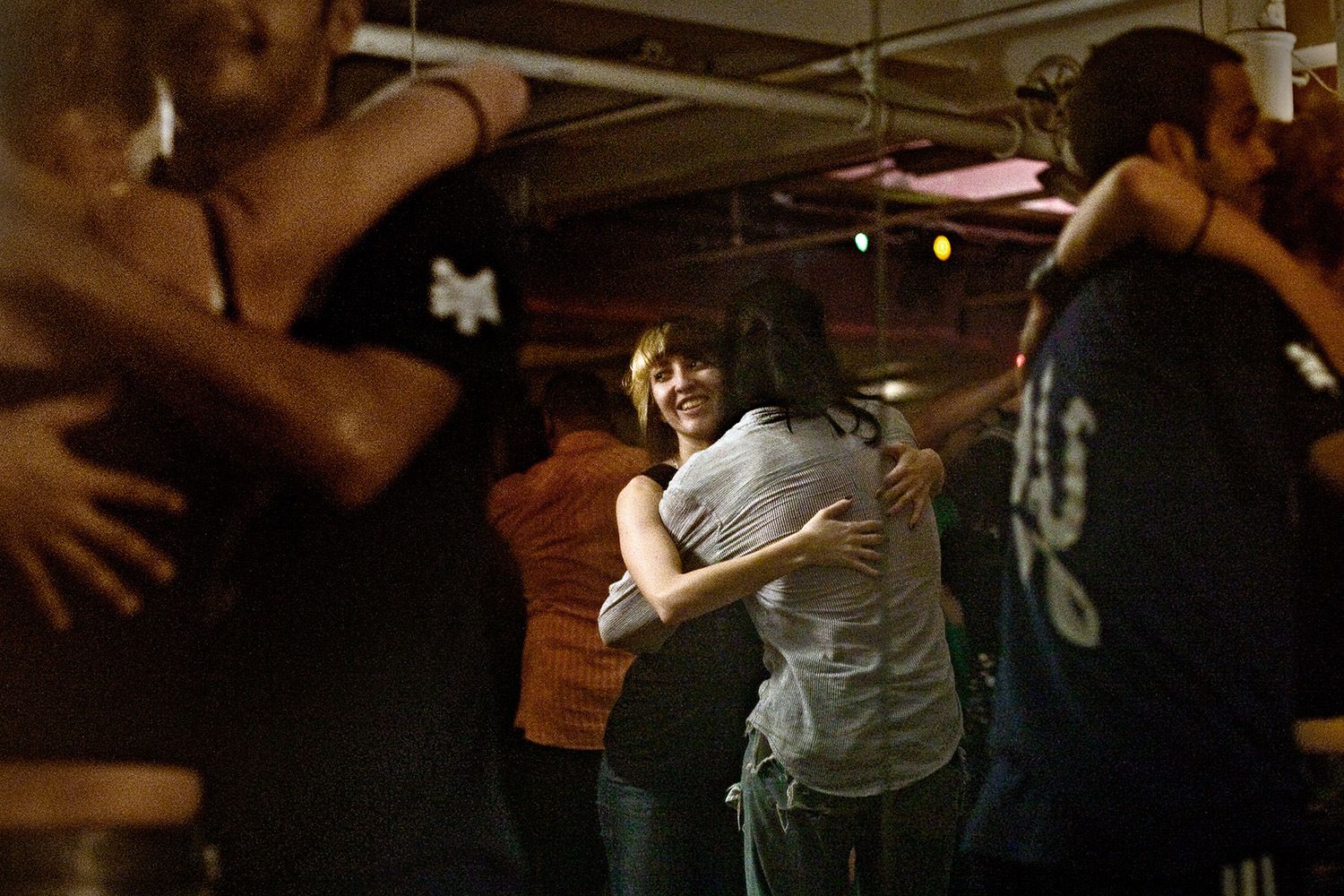 Dancers hug their partners at the end of a song at Jimmy Anton's