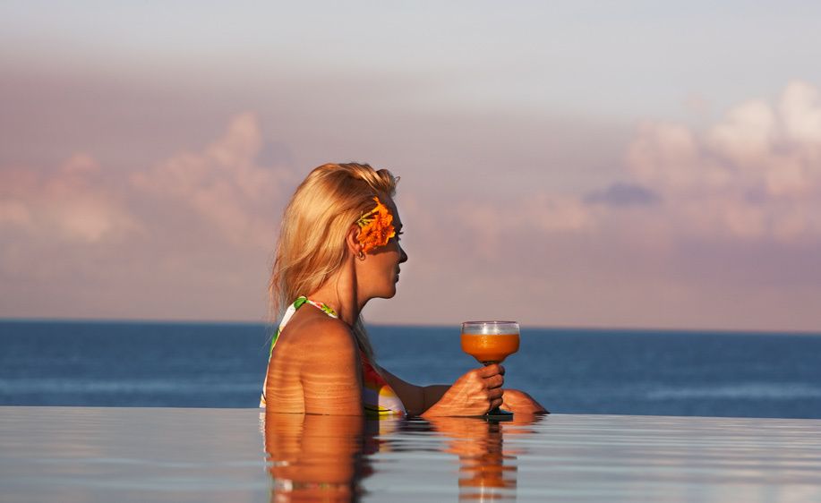 1Woman_in_pool_at_sunset_with_a_tropical_drink.jpg