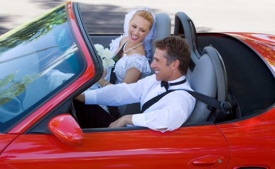 1Newlyweds_driving_in_a_red_convertible.jpg