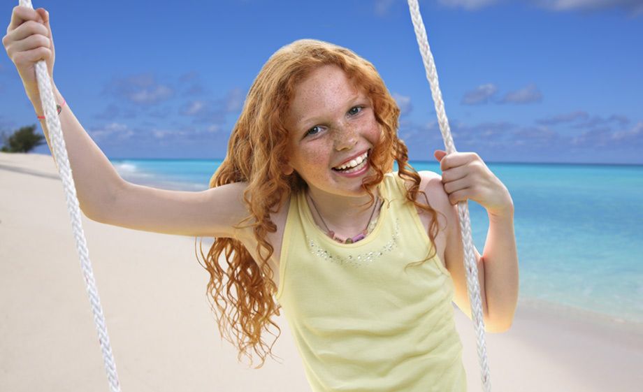 1Red_headed_girl_at_a_beach_on_a_swing.jpg