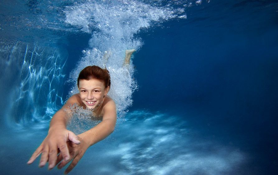1Underwater_view_of_a_boy_diving_in_pool.jpg
