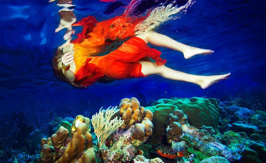 1Underwater_view_of_a_woman_floating_in_the_sea_above_reef_2.jpg