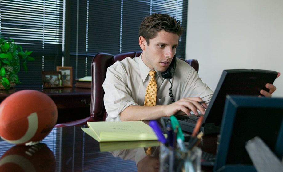 1Young_exec_on_a_laptop_football_on_his_desk.jpg
