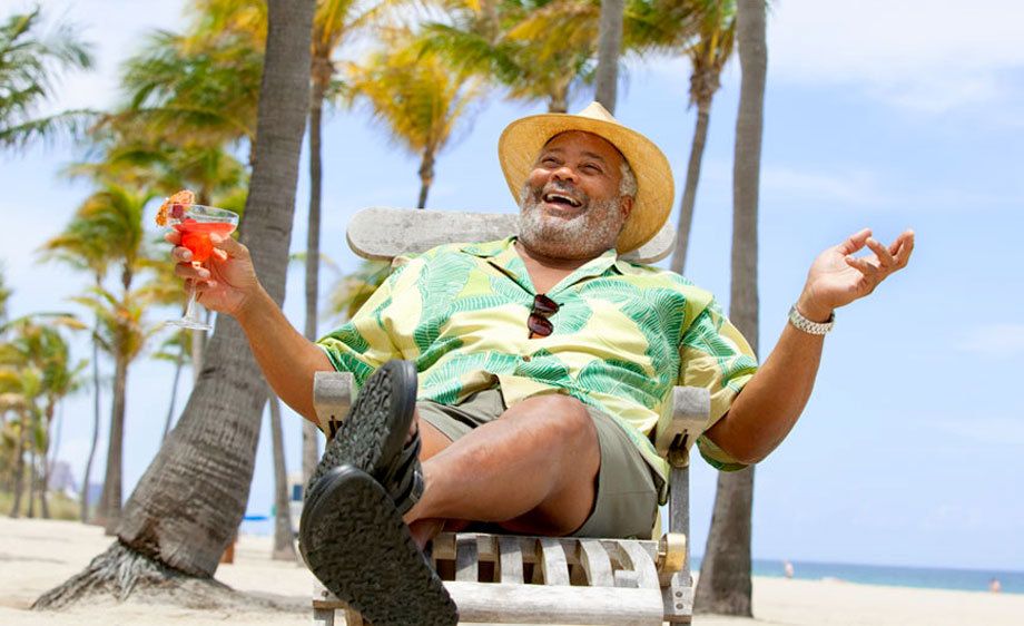 1Happy_man_relaxing_with_a_drink_at_tropical_beach.jpg