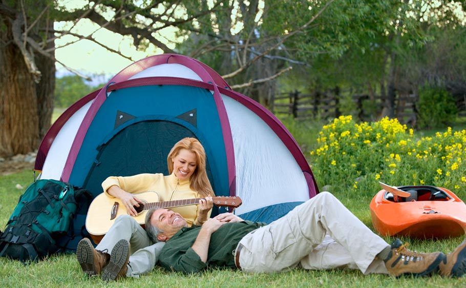 1Woman_playing_guitar_to_a_man_at_campsite.jpg