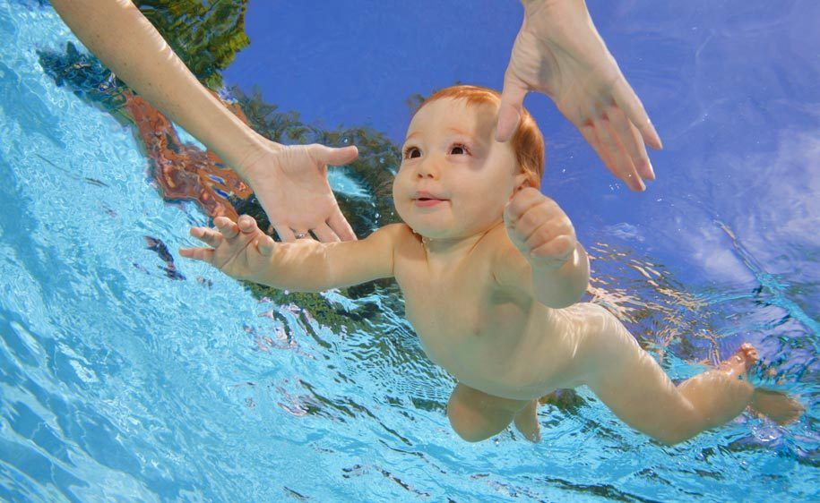 1Mother_reaching_for_her_swimming_baby.jpg