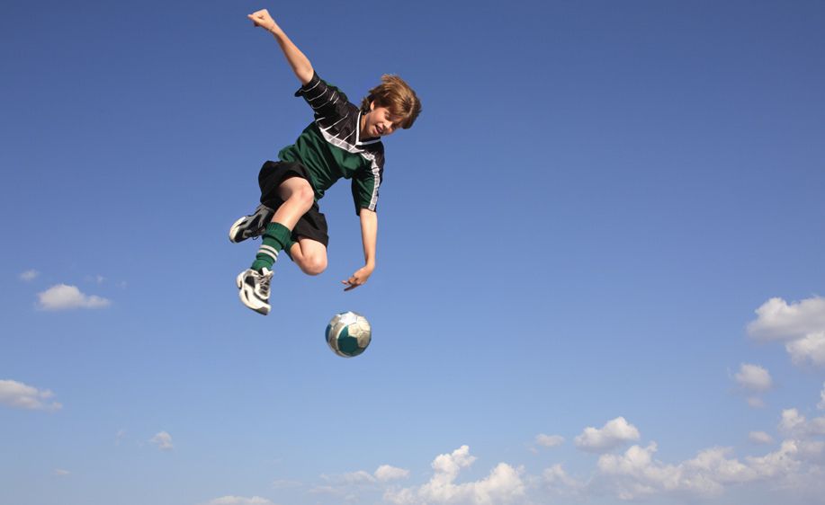 1Boy_kicking_soccer_ball_in_the_sky.jpg
