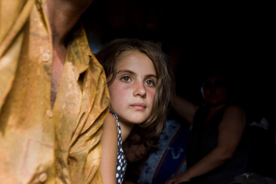 A young girl flees  with her family as Russian soldiers move deeper inside Georgian territory during a brief conflict. 