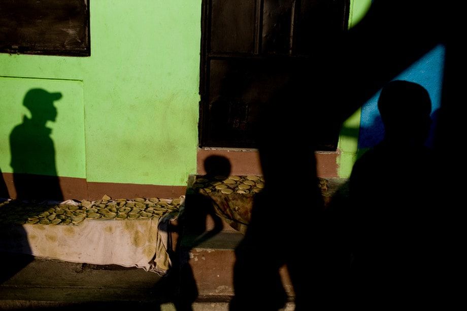 Daily life in Cite Soleil Haiti where people are known to purchase and eat cakes made of mud and salt water. 