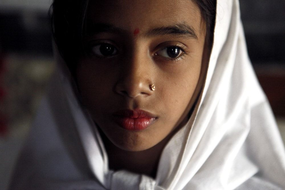 A young school girl who often passes out in class due to hunger.