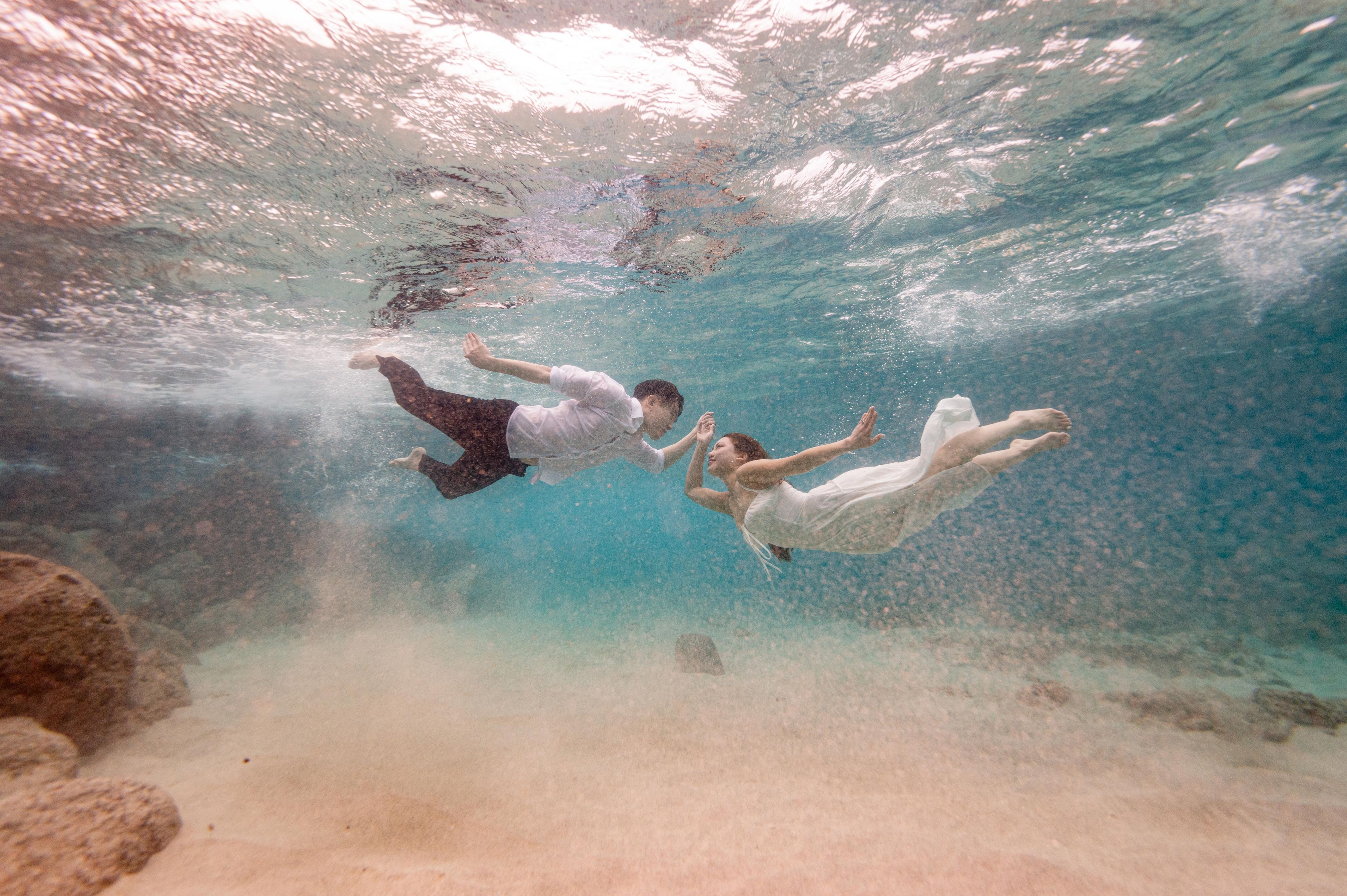 Couple diving underwater together Wedding