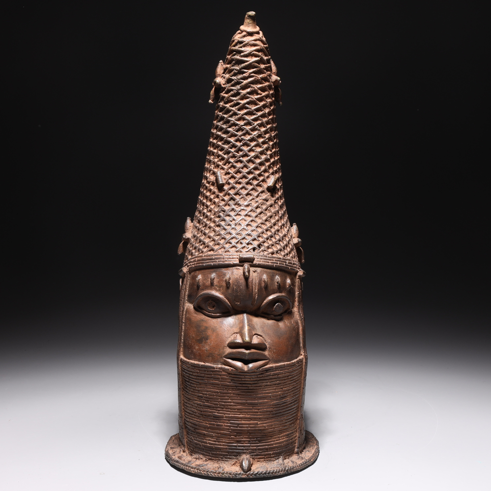 Auction photography of a Benin Kingdom Nigeria lost-wax cast bronze commemorative head of the Iyoba or Queen Mother with coral bead crown and neck rings. Photographed for I.M. Chait Gallery and featured on LiveAuctioneers by Los Angeles commercial photographer Victor Koroma. Benin Bronze Iyoba Queen Mother Head — I.M. Chait Auction Photography Victor Koroma