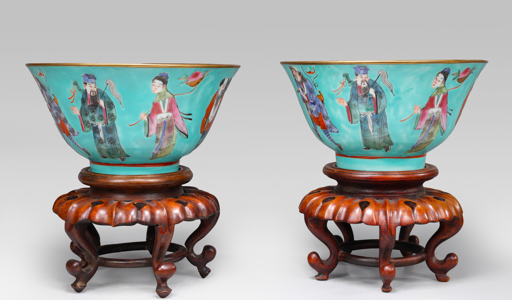 Auction photography of a pair of antique Chinese Famille Rose turquoise-ground porcelain bowls decorated with polychrome figures on iron-red clouds, on carved hardwood stands. Museum and auction collection photography by Los Angeles commercial photographer Victor Koroma. Chinese Famille Rose Turquoise Porcelain Bowl Pair — I.M. Chait Auction Photography