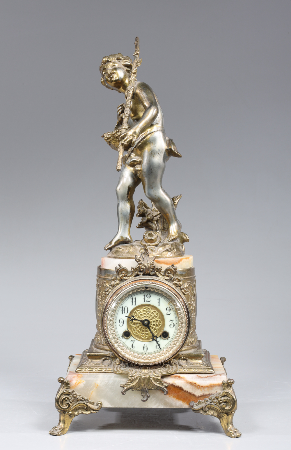 Auction photography of a late 19th to early 20th-century Victorian spelter mantel clock with gilt putto finial, onyx and marble base, and rococo-style bronze mounts. Museum and auction collection photography by Los Angeles commercial photographer Victor Koroma. Victorian Spelter Mantel Clock Putto Figure — I.M. Chait Auction Photography