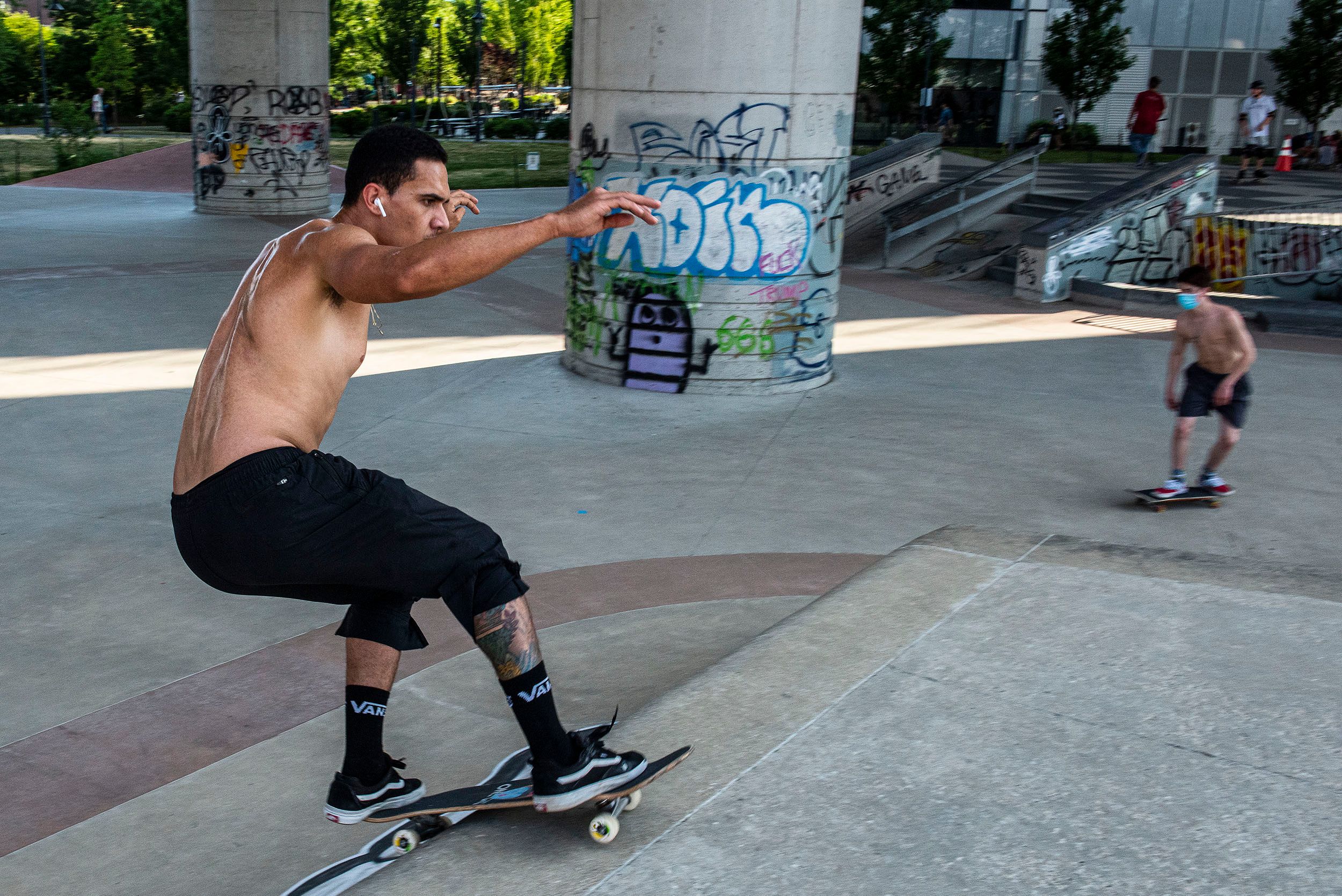 Photograph of skateboarders practicing their moves and skills at the Lynch Family Skateboard Park, Cambridge, MA practice makes perfect