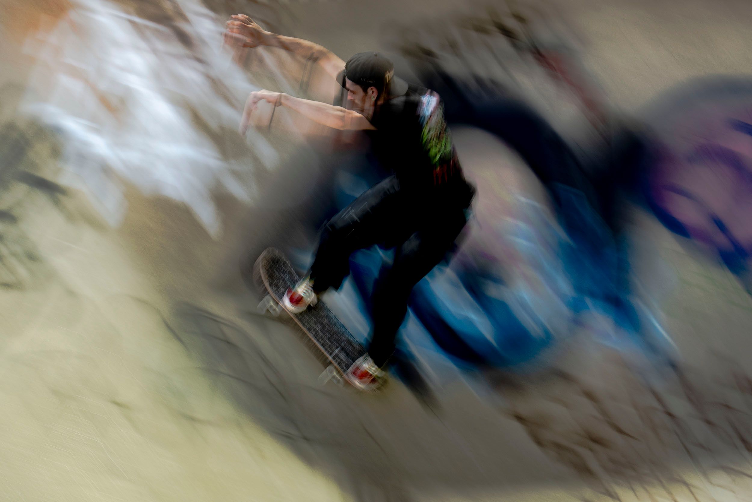 Color motion blur photograph of Jason Berry, a skateboarder doing a practice run at the Lynch Family Skateboard Park. Cambridge, MA Speed and Balance