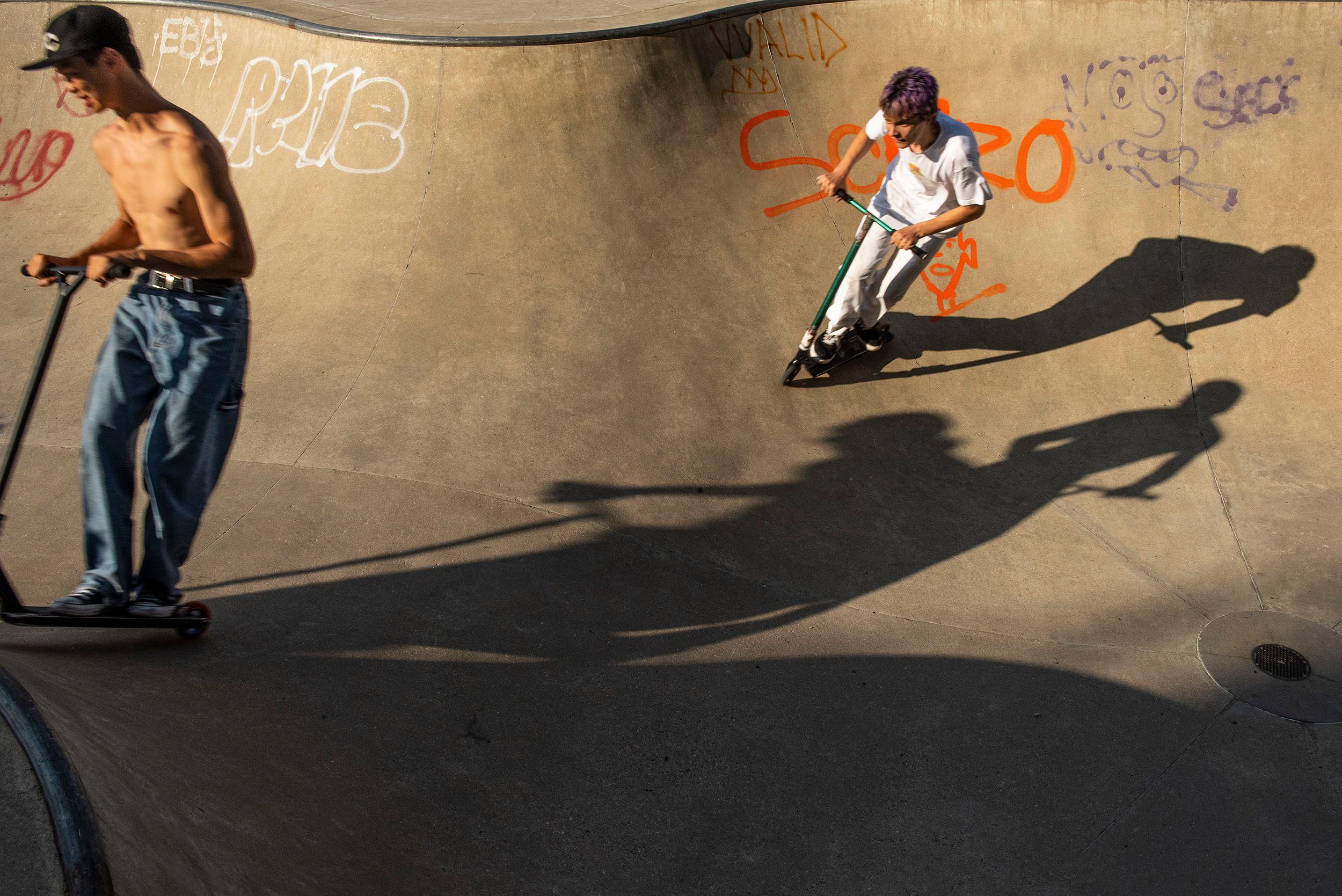 Photograph scooter riders practicing their moves and skills at the Lynch Family Skateboard Park, Cambridge, MA Fun at the skateboard park