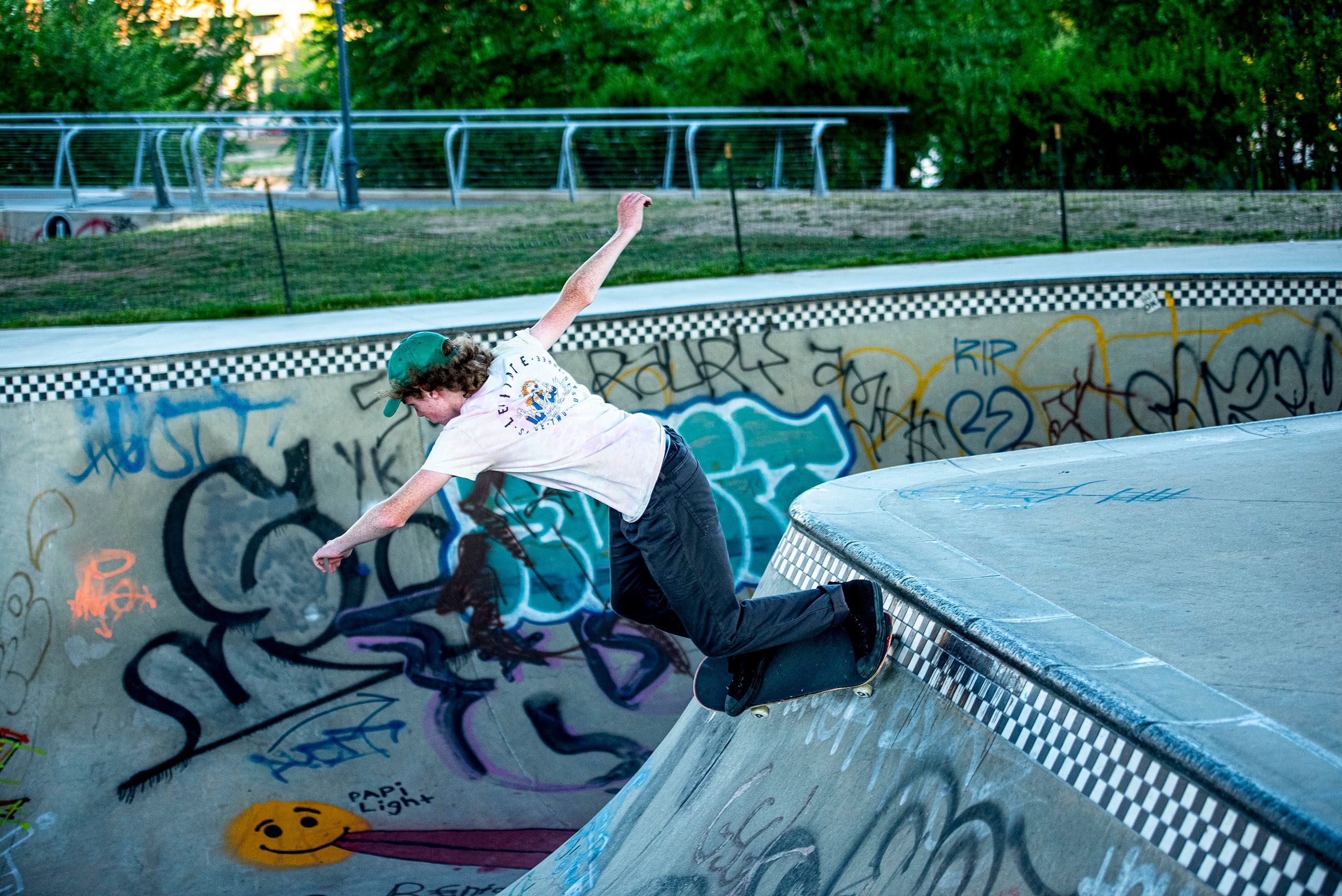 Photograph of skateboarder practicing a run in the cement bowl at the Lynch Family Skateboard Park, Cambridge, MA Balance