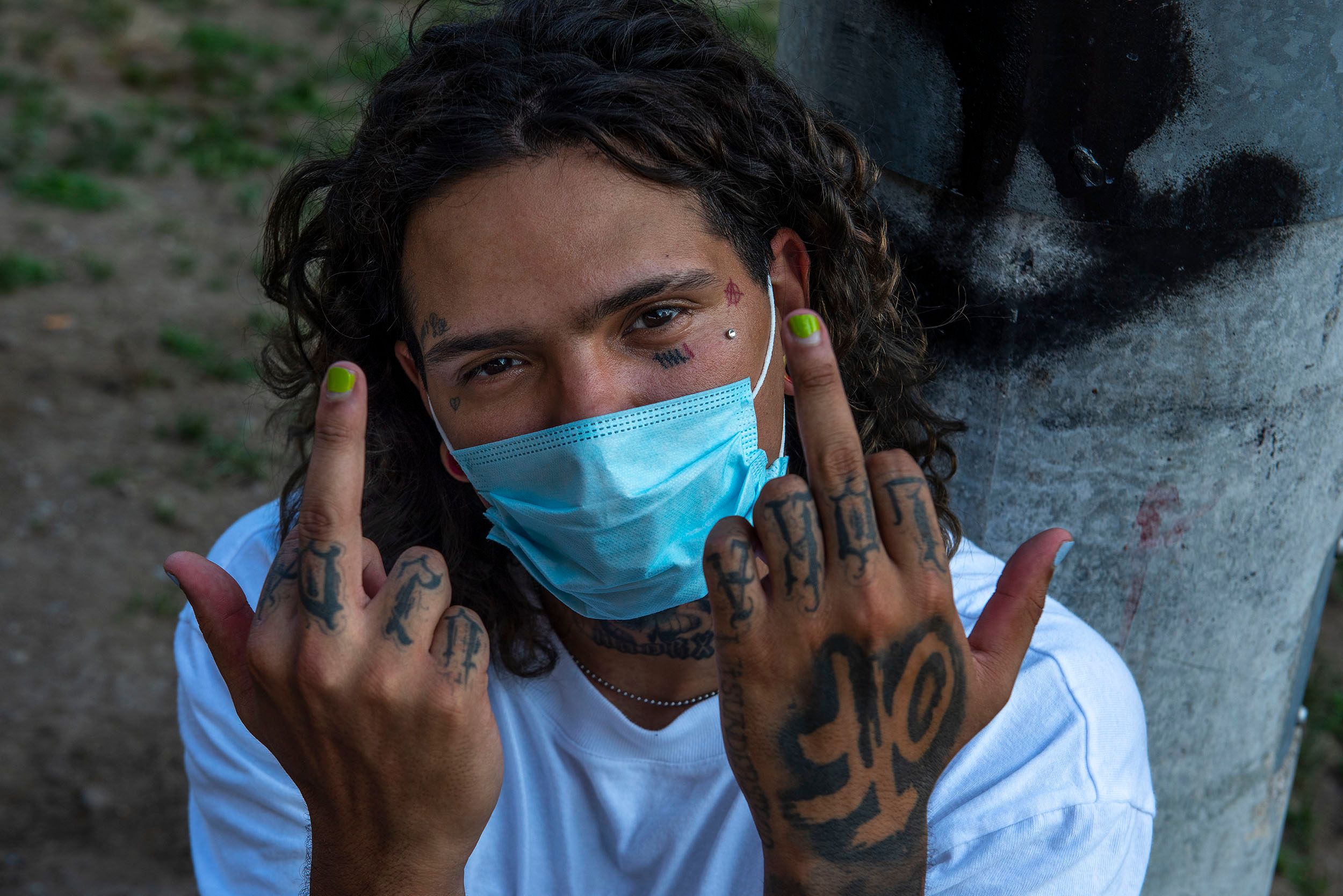 Horizontal color photograph of Rico Sixx, a skateboarder with face mask and giving the middle fingers at the Lynch Family Skateboard Park, Cambridge, MA Rico Sixx