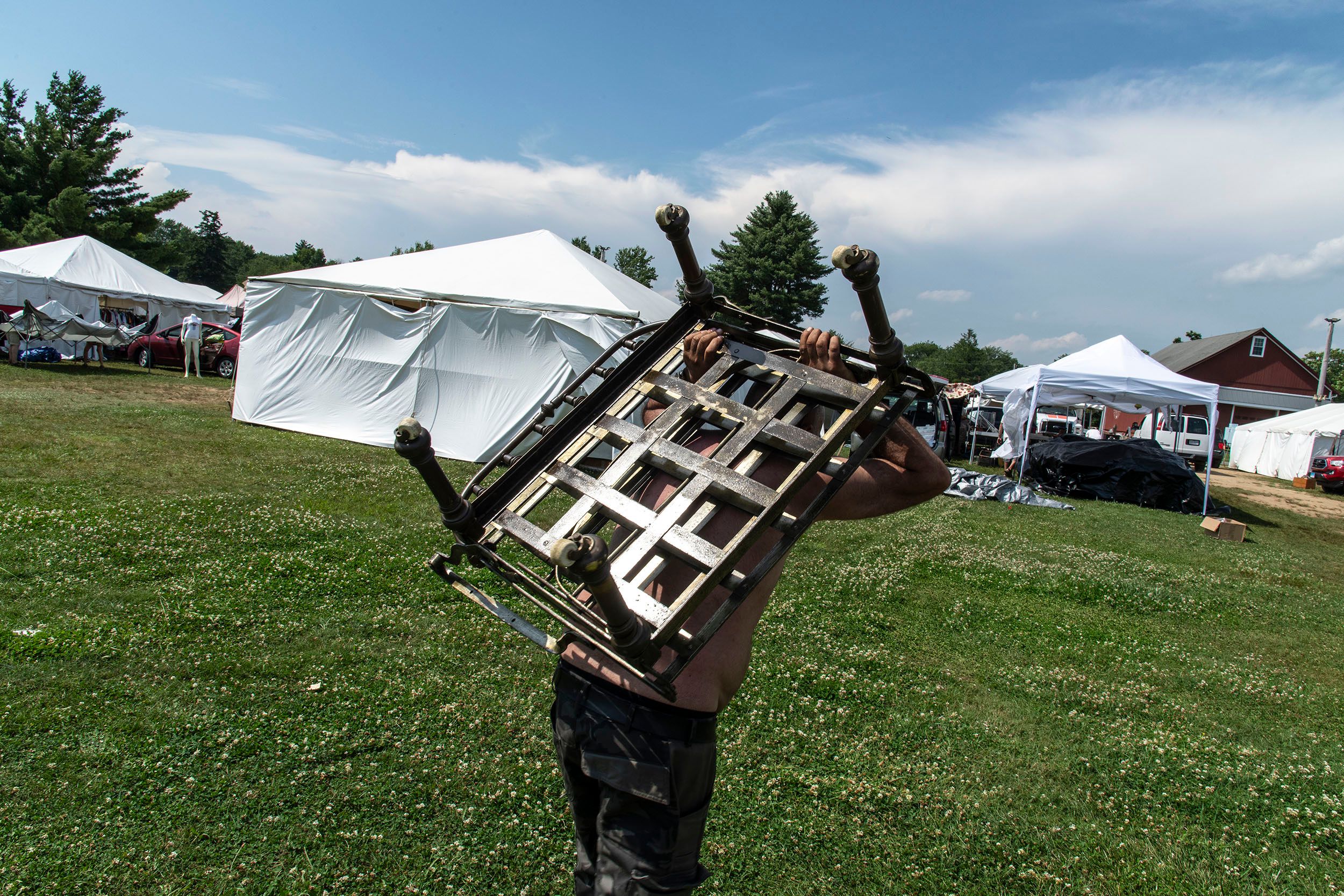 Person hauling a piece of furniture to their car. Bizarroland