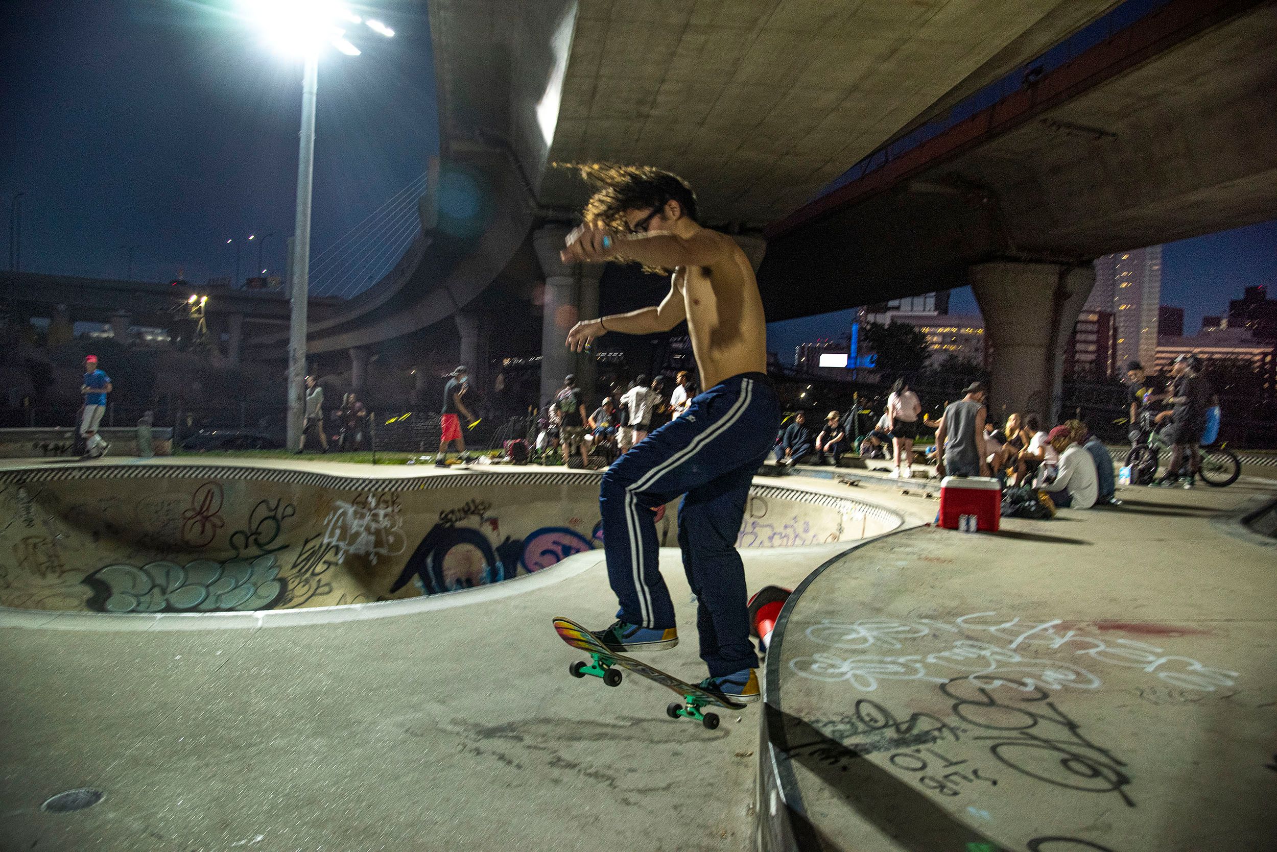 Photograph of a skateboarder jumping a wall at the Lynch Family Skateboard Park in Cambridge, MA Jumping a wall