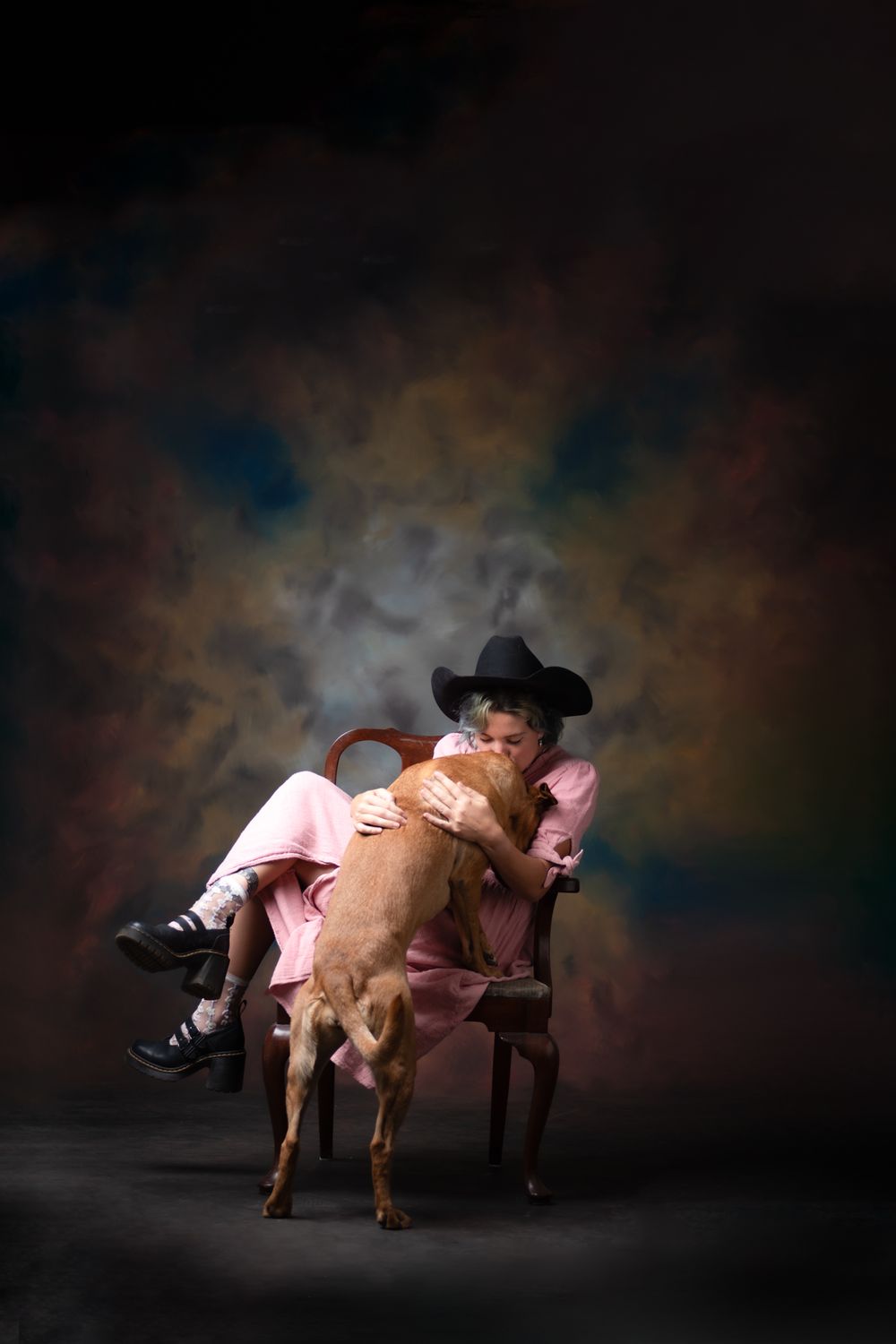 A studio portrait of a girl and her dog