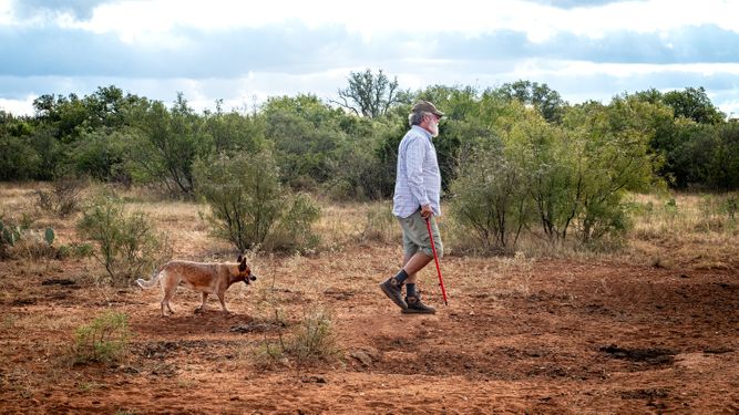 a man and his dog walking at White Ranch