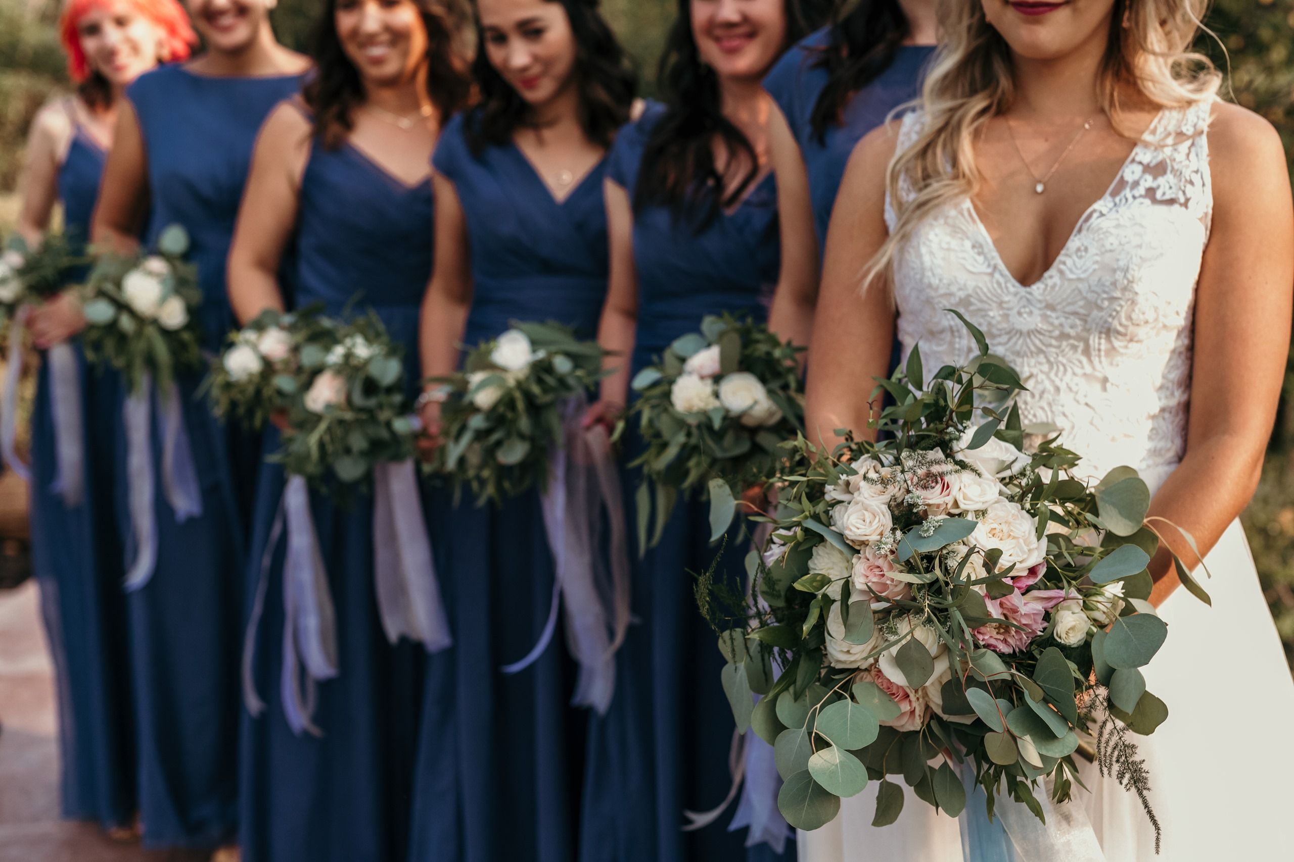 Bride and Bridesmaids in line with bouquets