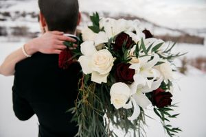 Bride and groom showing bouquet