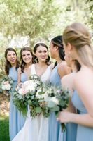 Bride smiling with bridesmaids