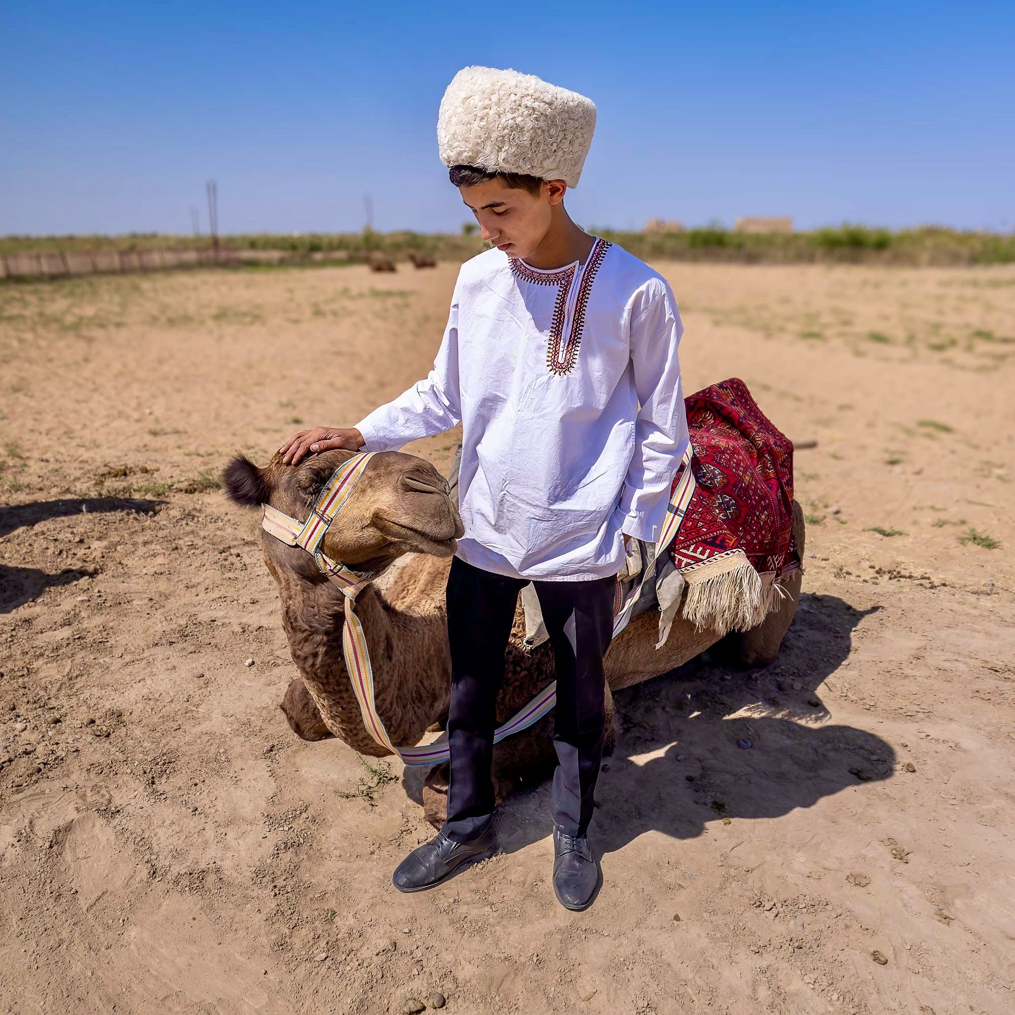 A boy and his camel. Bayramaly, Turkmenistan