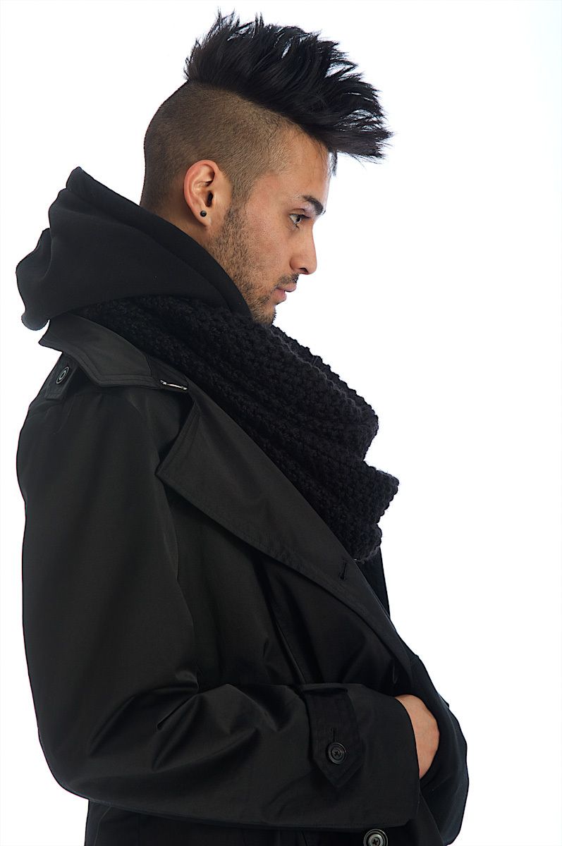 young modern man with mohawk in black in profile modern man