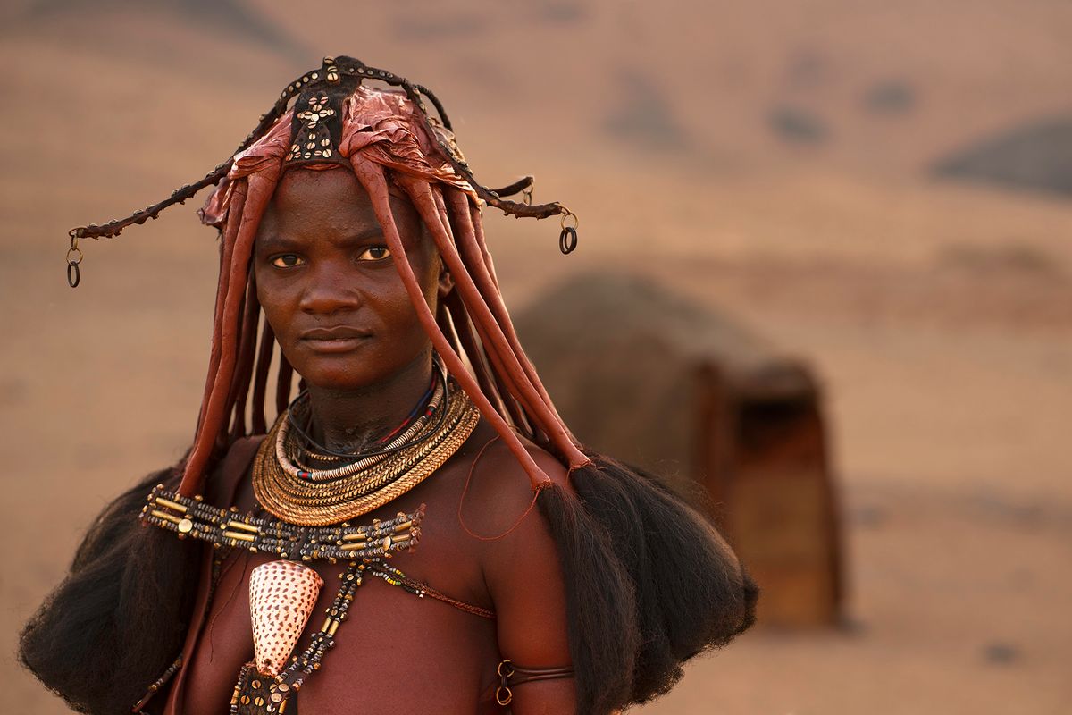 Himba Woman in front of Hut