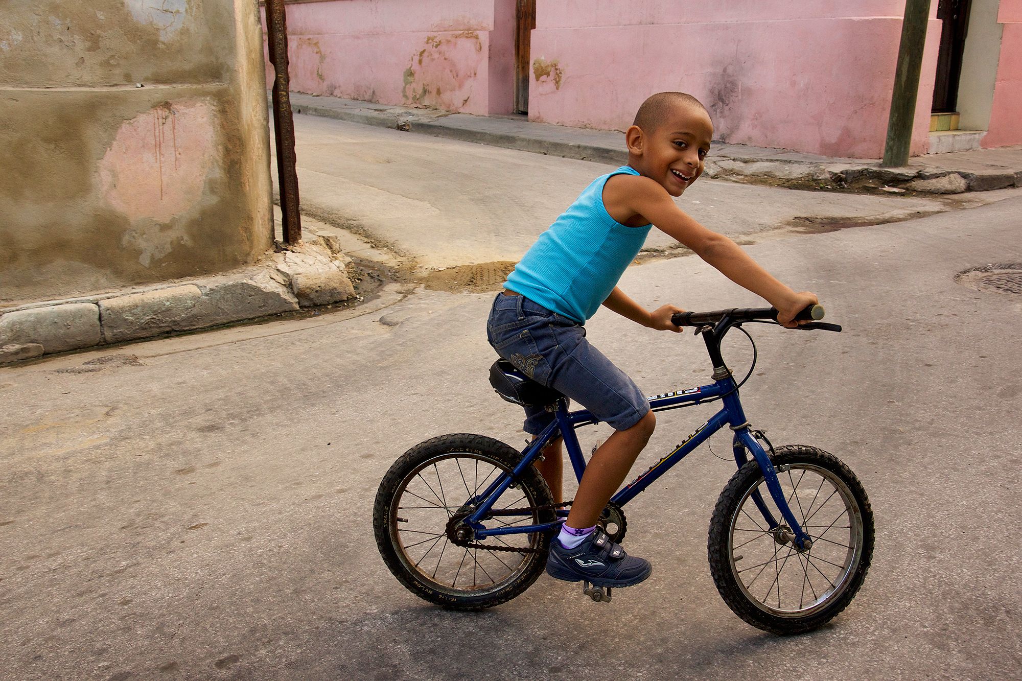 Happy boy on his bicycle in Cuba. Santiago de Cuba Young Cuban boy