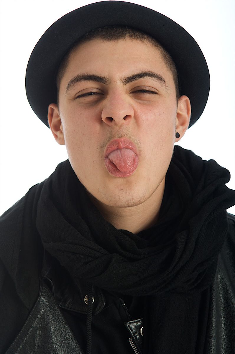 boy making a face with his tongue out sticking your tongue out