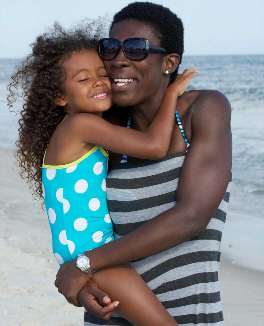African American Mother hugging her 5 year old daughter at the beach pictures mother and daughter pictures