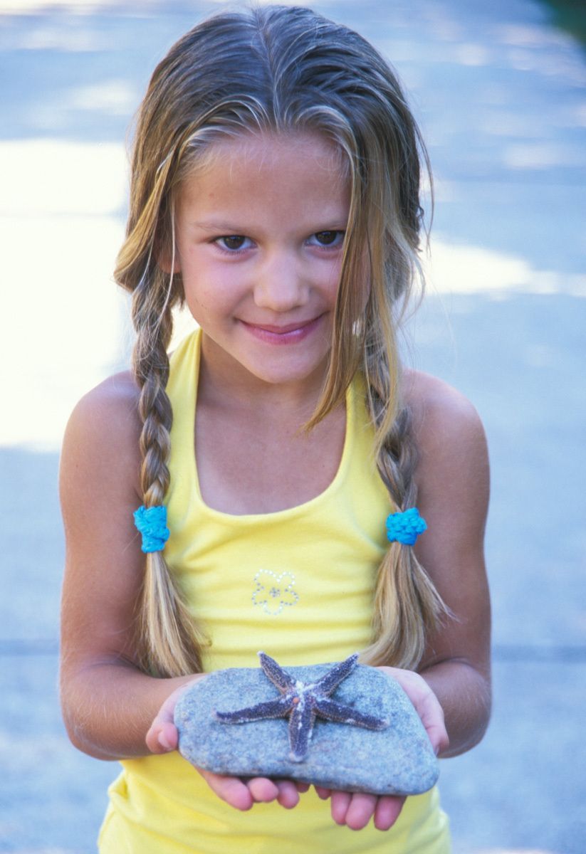 Child holding starfish Child holding starfish
