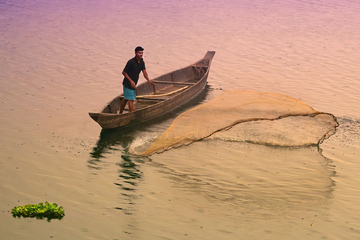 Fisherman casting his net