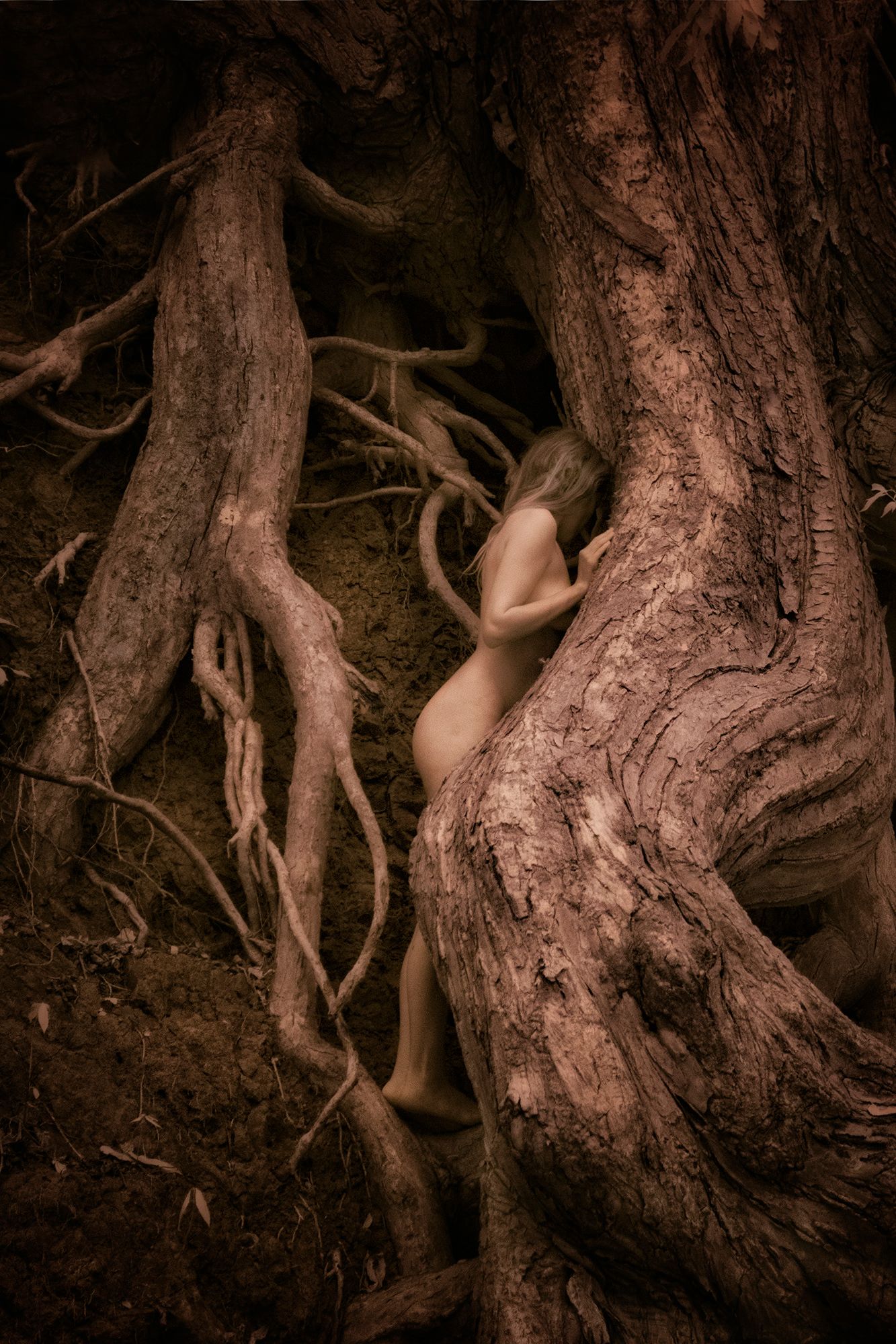 standing nude among the roots