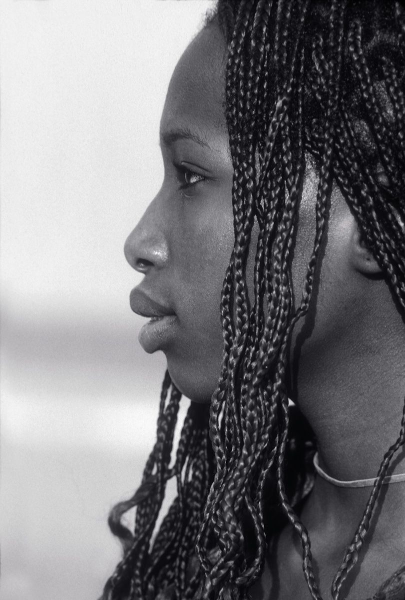 black and white profile picture of young african american woman with corn row hair cornrole picture