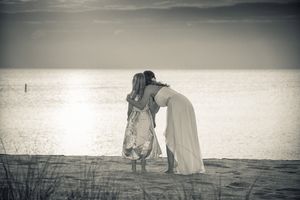 Bride and Daughter hugging oceanside - Black & White