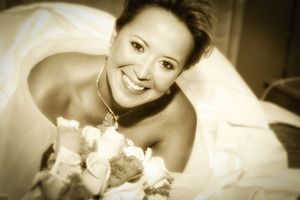 Black & White photograph Bride on bed with flowers