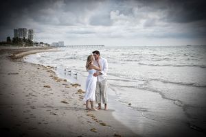 Barefoot wedding couple kissing on beach