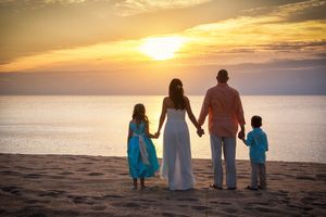 Wedding day on the beach at sunrise with daughter and son.
