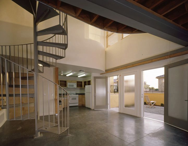 Spiral stair ascends to the living space above. 1Historic_Old_School_Lofts_4