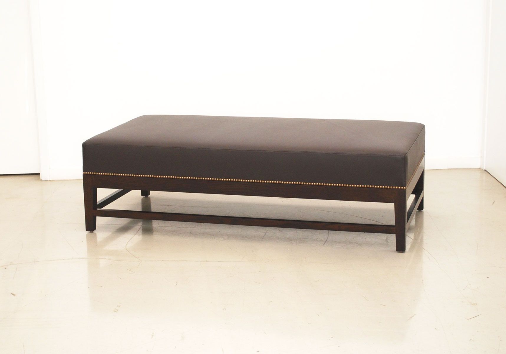 Custom leather ottoman with nail head detail