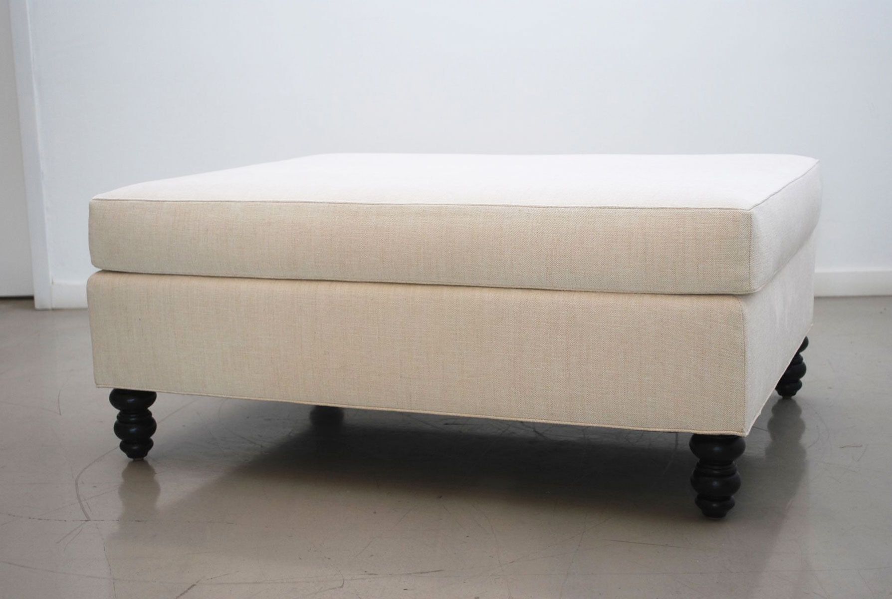 Custom ottoman with hand-turned feet